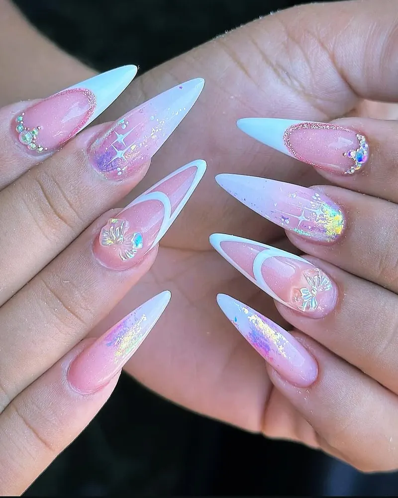 Baby-blue French stiletto nails with aurora flakes, crystals and a small bow