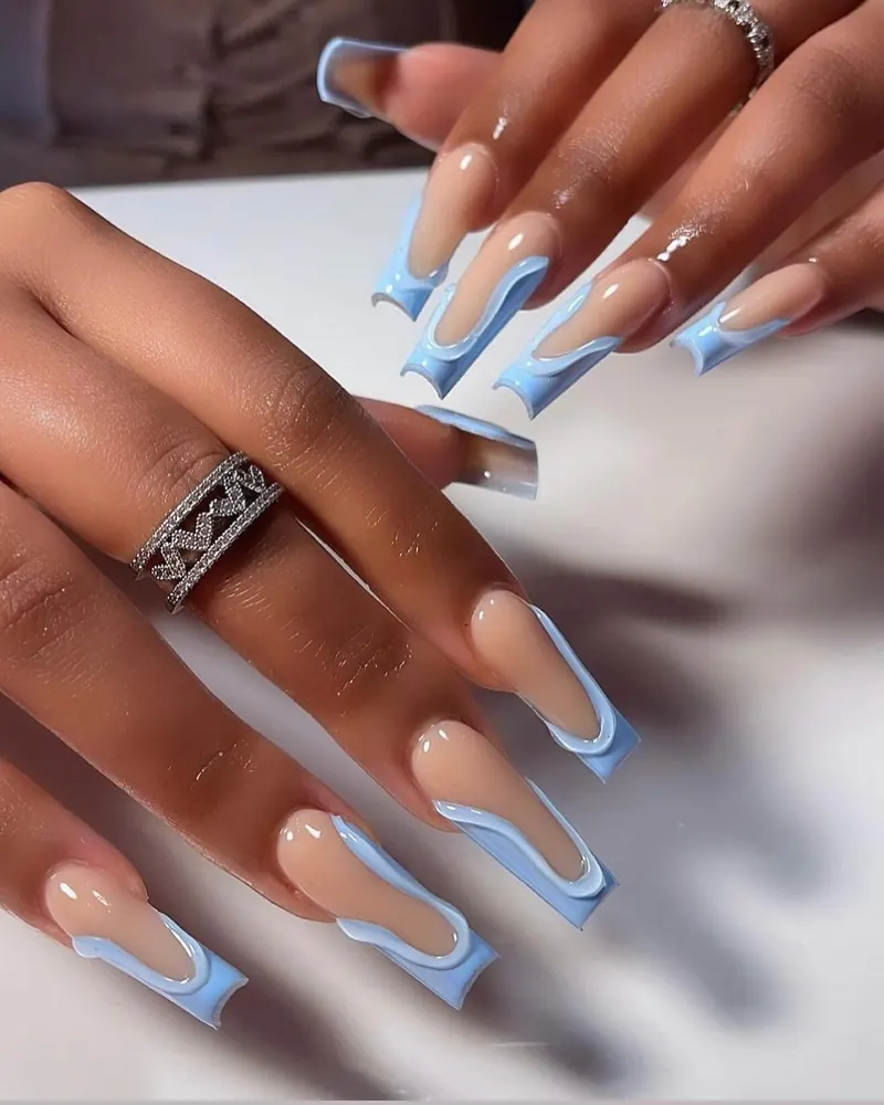 Long nude coffin nails with a baby-blue wavy French outline