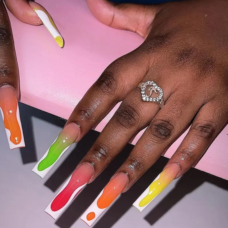 Long square nails with hand-painted drips in lime, red, orange and yellow