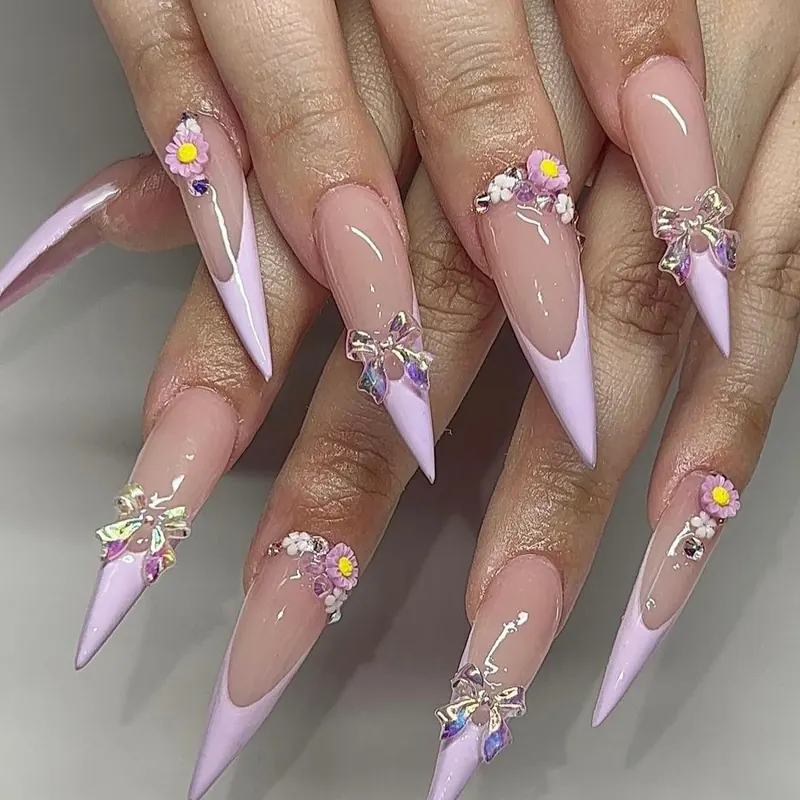 Lilac French stiletto nails with 3D bow charms, flowers and crystals