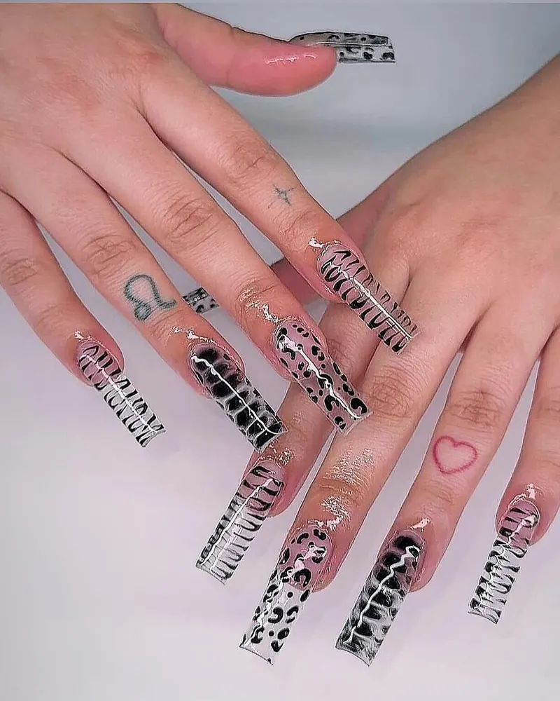 Clear long coffin nails with black zebra and leopard print and a red heart
